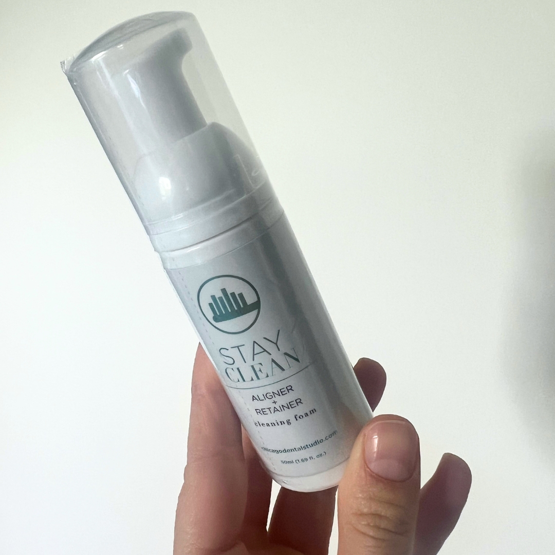 Hand holding the Stay Clean cleaning foam